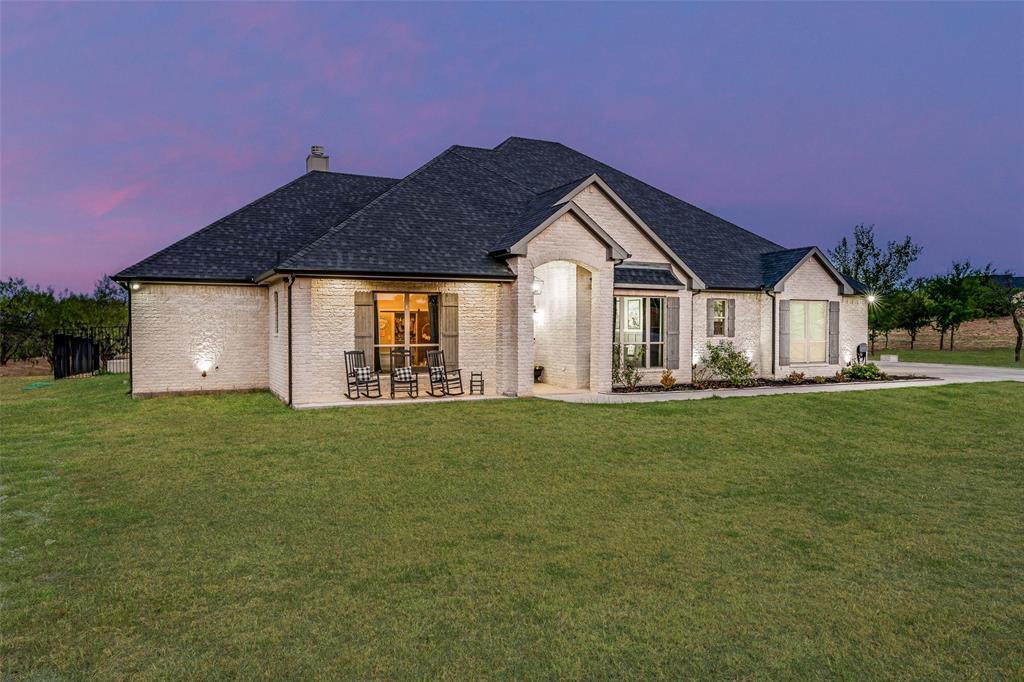101 Trail Ridge Weatherford, TX 76087 - Photo 37 of 39 a front view of a house with a garden and yard