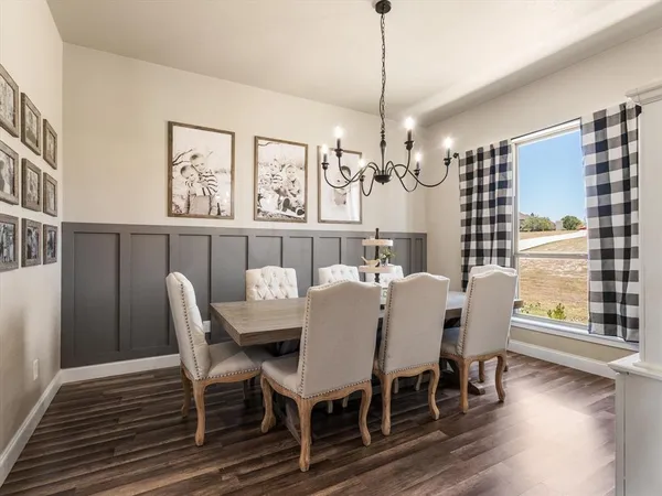 a view of a dining room with furniture wooden floor and chandelier