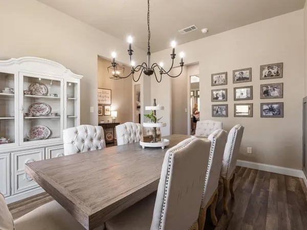 a living room with furniture a large window and a chandelier