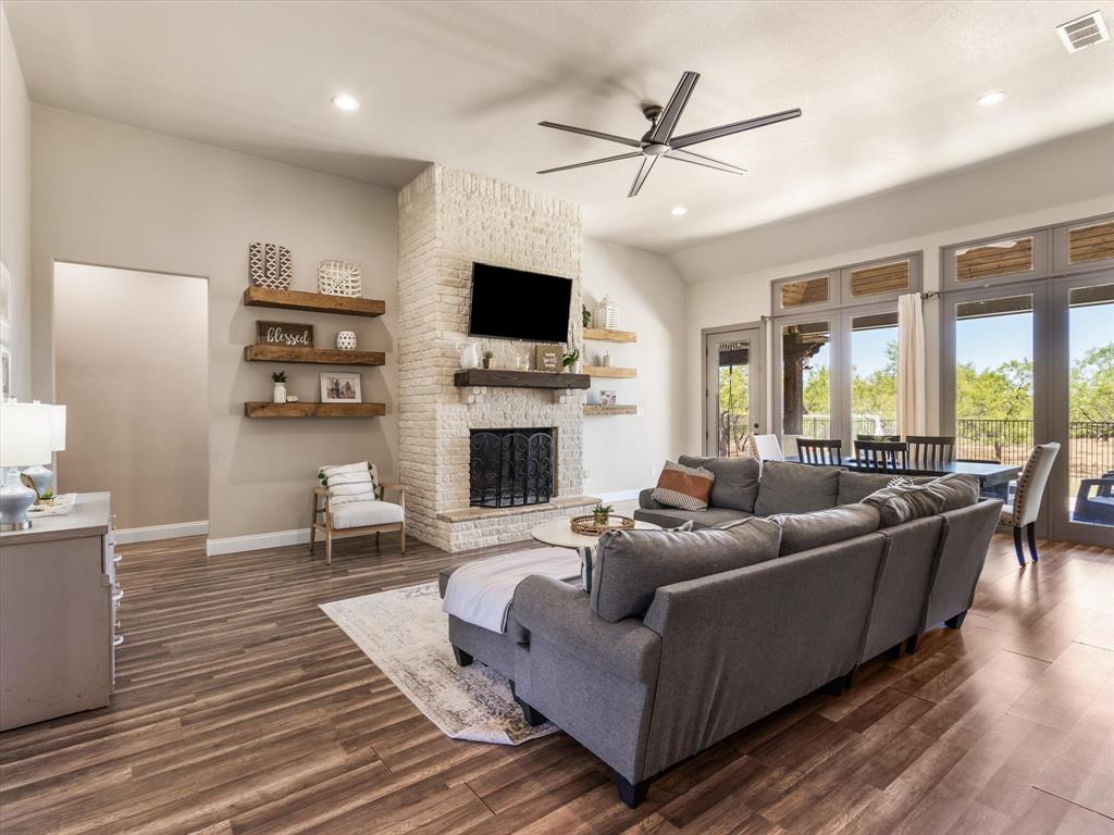 101 Trail Ridge Weatherford, TX 76087 - Photo 7 of 39 a living room with furniture a flat screen tv and a fireplace