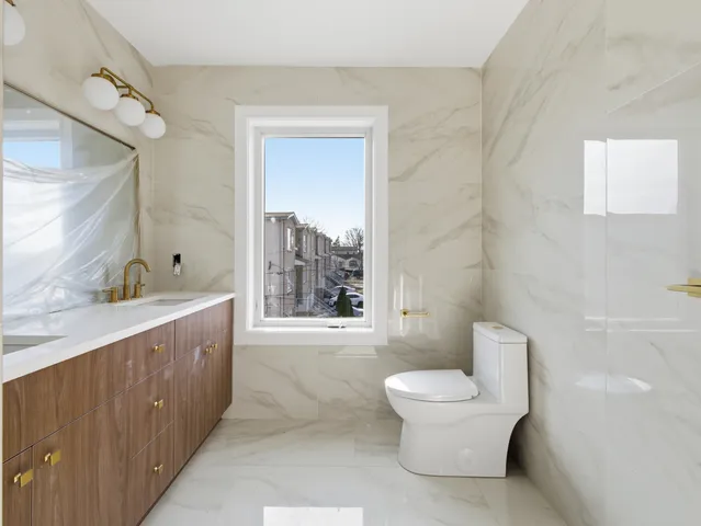 a bathroom with a granite countertop toilet a sink and a bathtub