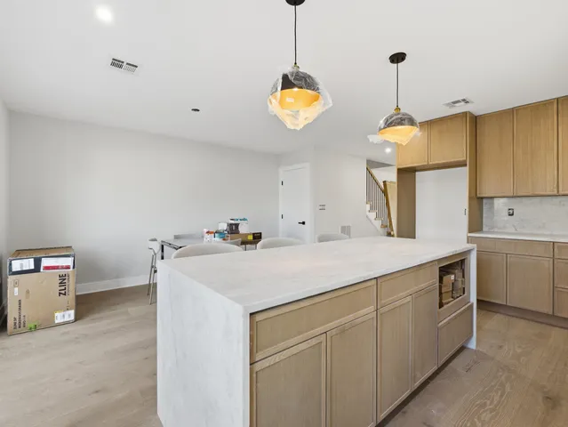 a kitchen with kitchen island a sink appliances and a center island