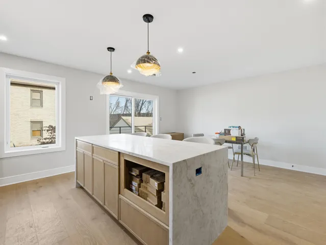 a kitchen with a stove and a wooden floor