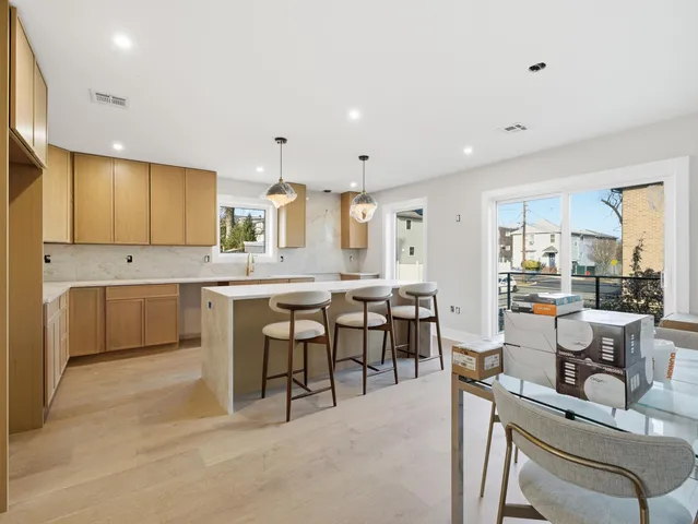 a large kitchen with a table and chairs