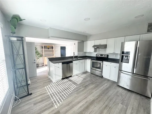 a view of a walk in closet and wooden floor