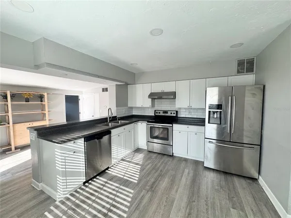 an empty room with windows and closet