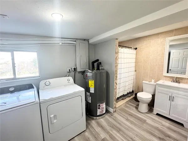 a bathroom with a sink a toilet a shower and a mirror