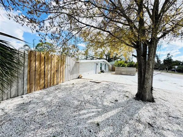 a view of a yard with a tree
