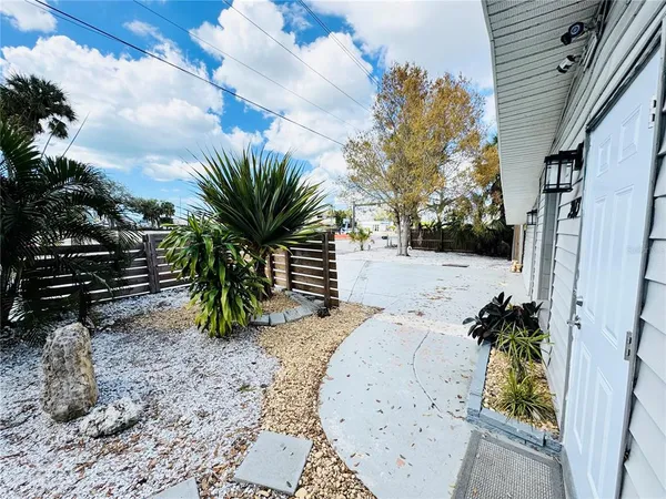 a large open kitchen with stainless steel appliances kitchen island granite countertop a refrigerator and stove top oven