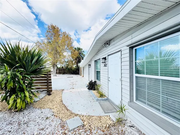 a view of a room with wooden floor and potted plant