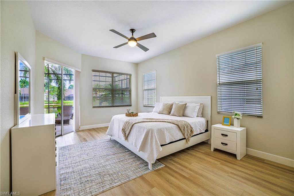 5235 Malvern Court Naples, FL 34112 - Photo 13 of 28 a spacious bedroom with a bed and a window