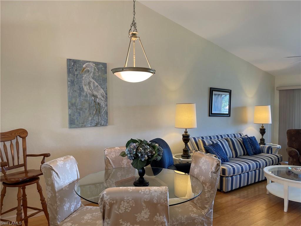9009 Michael Circle, Unit 1110 Naples, FL 34113 - Photo 11 of 48 a living room with furniture a couch and a chandelier