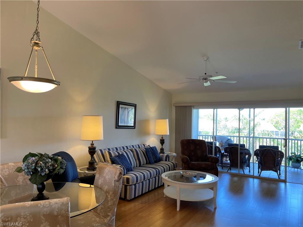9009 Michael Circle, Unit 1110 Naples, FL 34113 - Photo 12 of 48 a living room with furniture and a large window