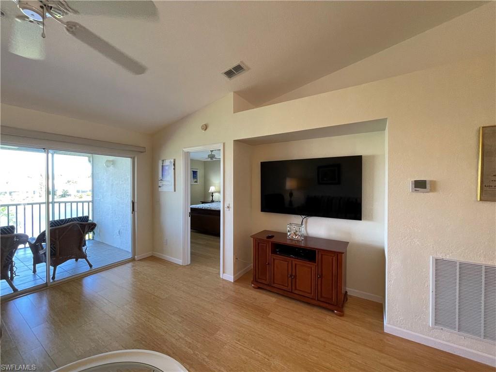 9009 Michael Circle, Unit 1110 Naples, FL 34113 - Photo 15 of 48 a living room with furniture and a flat screen tv