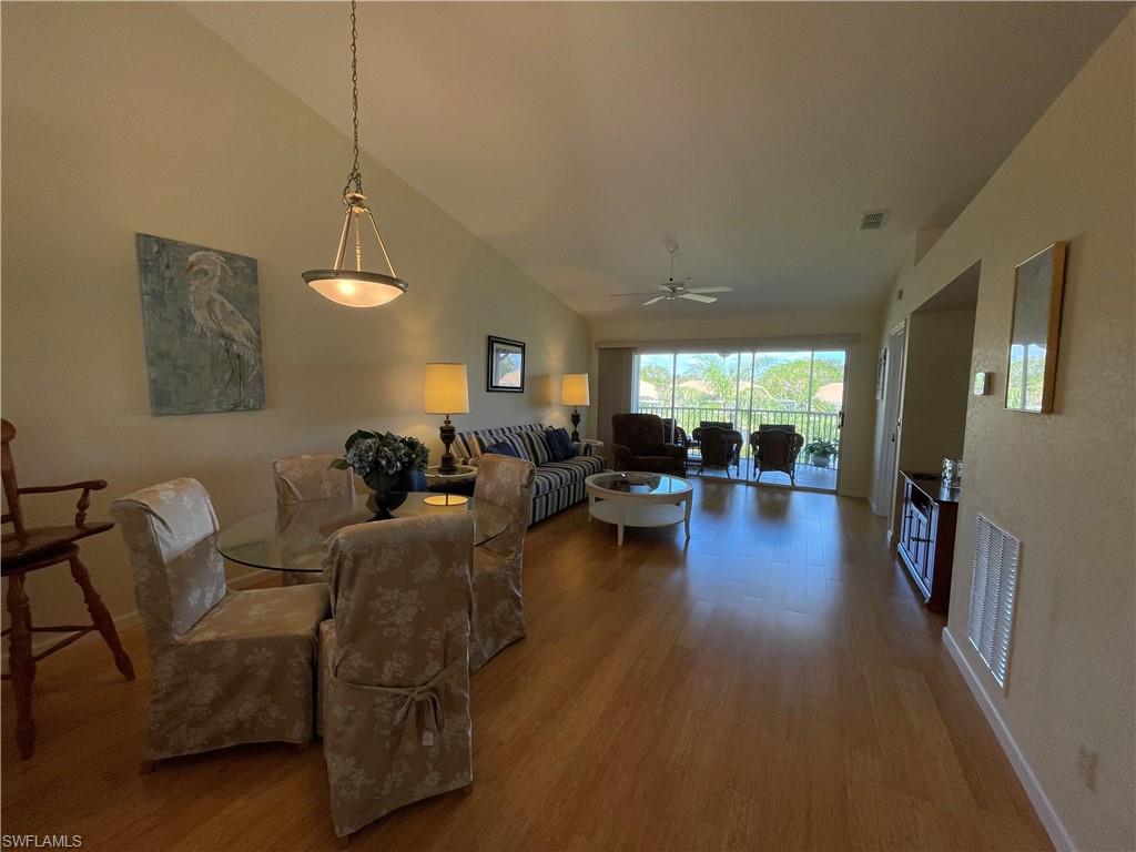 9009 Michael Circle, Unit 1110 Naples, FL 34113 - Photo 18 of 48 a living room with furniture and a wooden floor