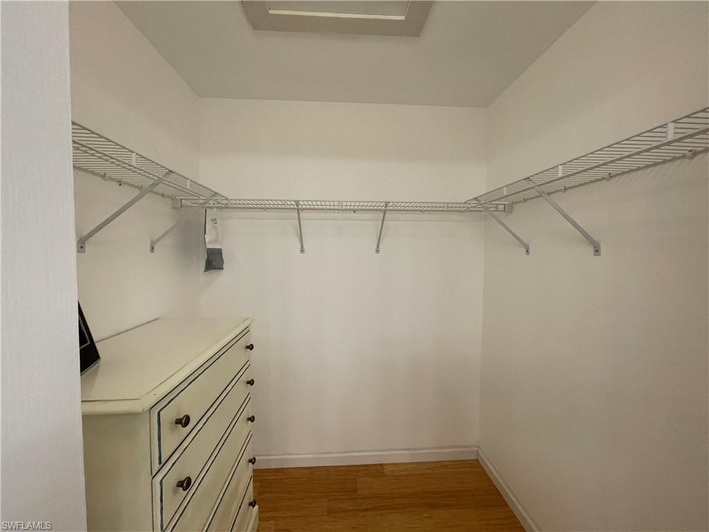 9009 Michael Circle, Unit 1110 Naples, FL 34113 - Photo 26 of 48 a view of walk in closet with empty racks
