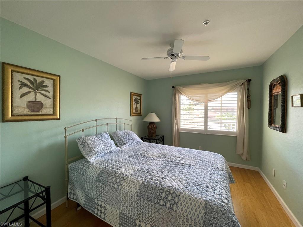 9009 Michael Circle, Unit 1110 Naples, FL 34113 - Photo 27 of 48 a bedroom with a large bed and a window