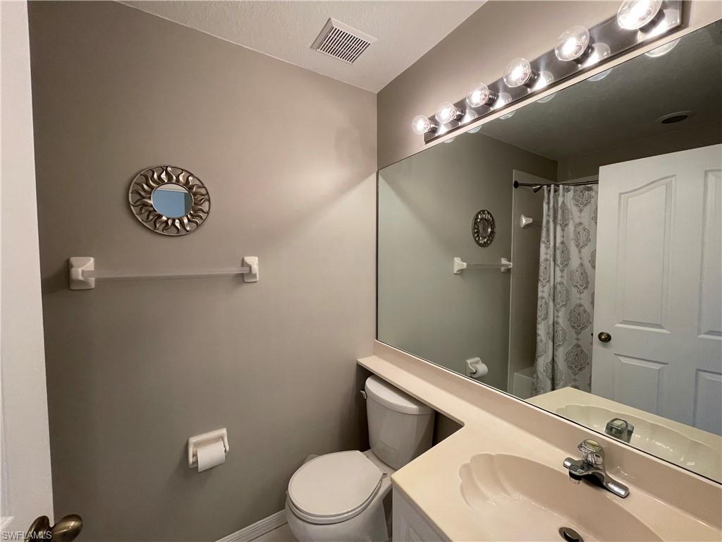 9009 Michael Circle, Unit 1110 Naples, FL 34113 - Photo 29 of 48 a bathroom with a sink a toilet and shower