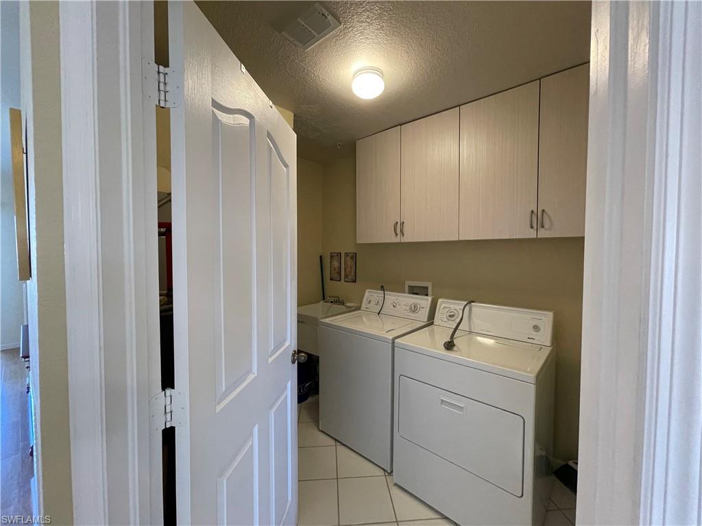 9009 Michael Circle, Unit 1110 Naples, FL 34113 - Photo 30 of 48 a utility room with dryer and washer