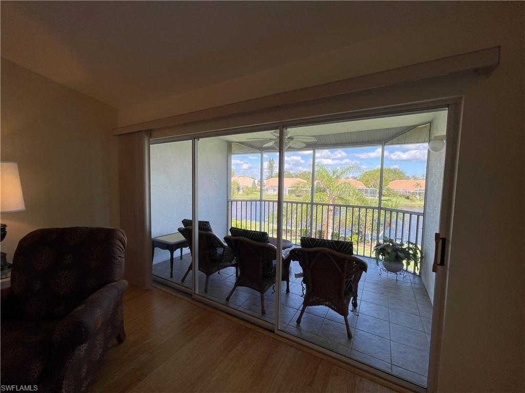 9009 Michael Circle, Unit 1110 Naples, FL 34113 - Photo 31 of 48 a living room with furniture and a large window