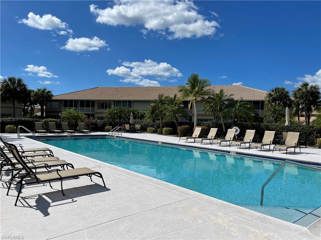 9009 Michael Circle, Unit 1110 Naples, FL 34113 - Photo 36 of 48 a view of a swimming pool with a patio