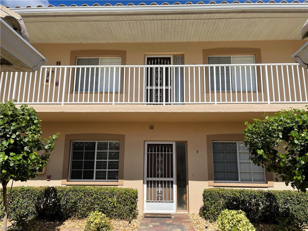 9009 Michael Circle, Unit 1110 Naples, FL 34113 - Photo 38 of 48 a front view of a house with a garden