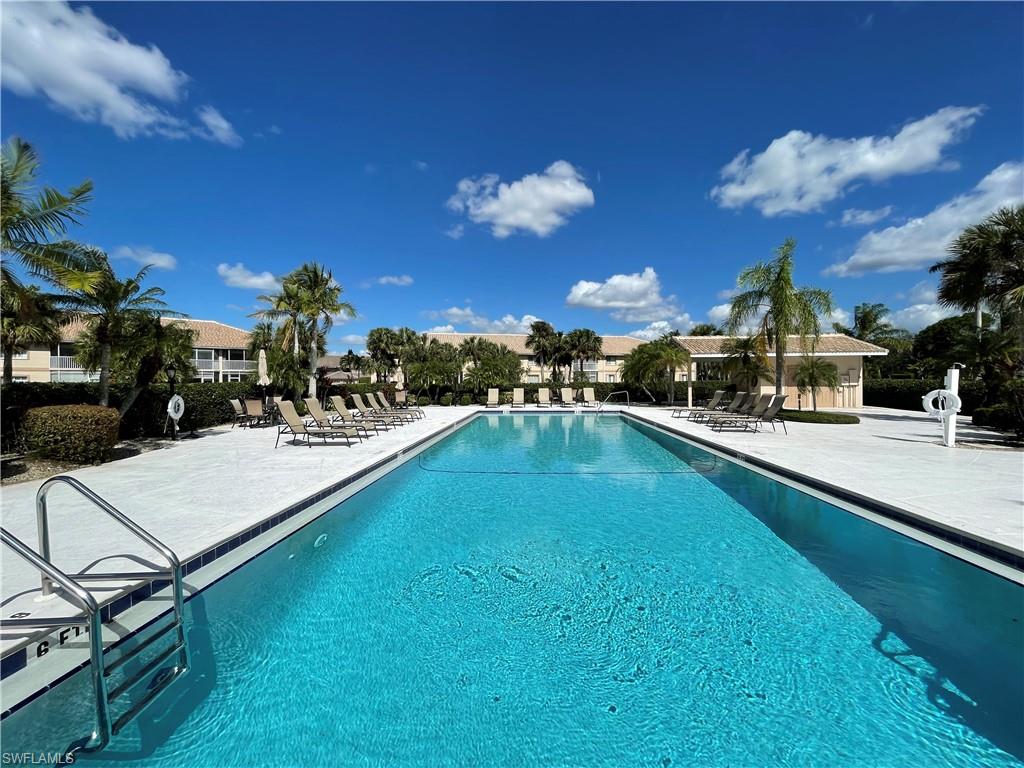 9009 Michael Circle, Unit 1110 Naples, FL 34113 - Photo 40 of 48 a view of a swimming pool with outdoor seating
