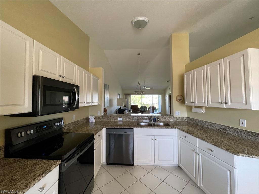 9009 Michael Circle, Unit 1110 Naples, FL 34113 - Photo 4 of 48 a kitchen with a sink stove top oven and cabinets