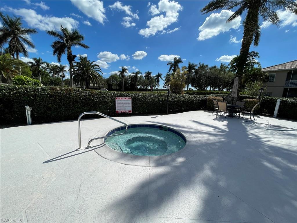 9009 Michael Circle, Unit 1110 Naples, FL 34113 - Photo 41 of 48 a swimming pool with outdoor seating and city view