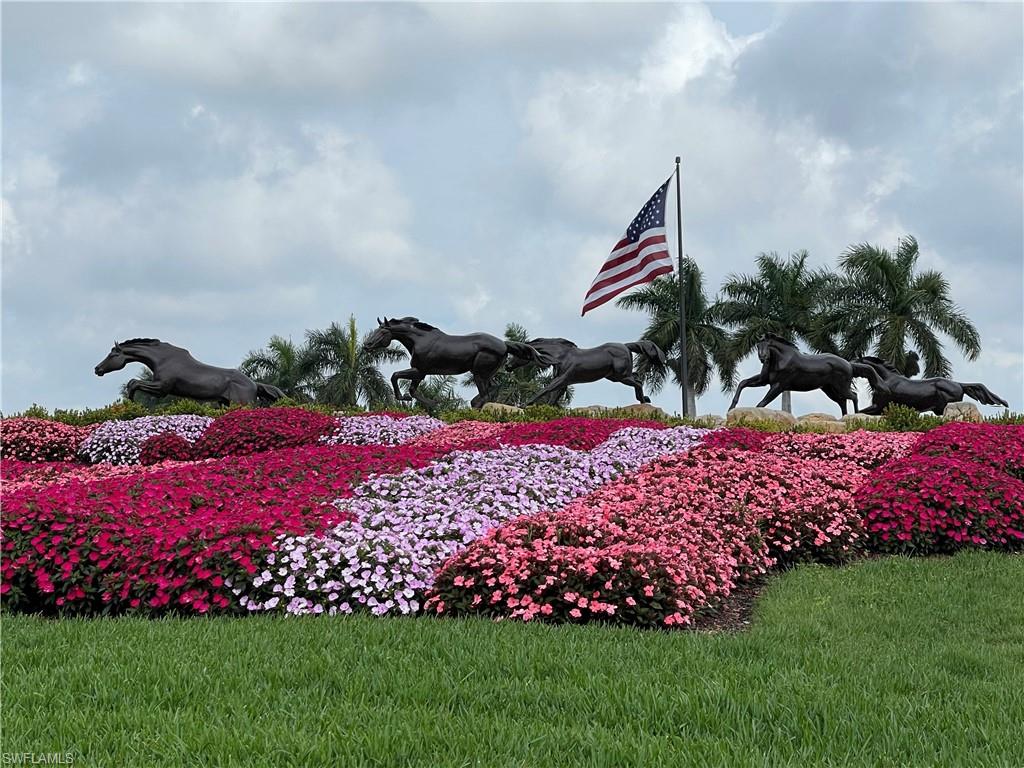 9009 Michael Circle, Unit 1110 Naples, FL 34113 - Photo 43 of 48 a front view of a house with a yard and flowers