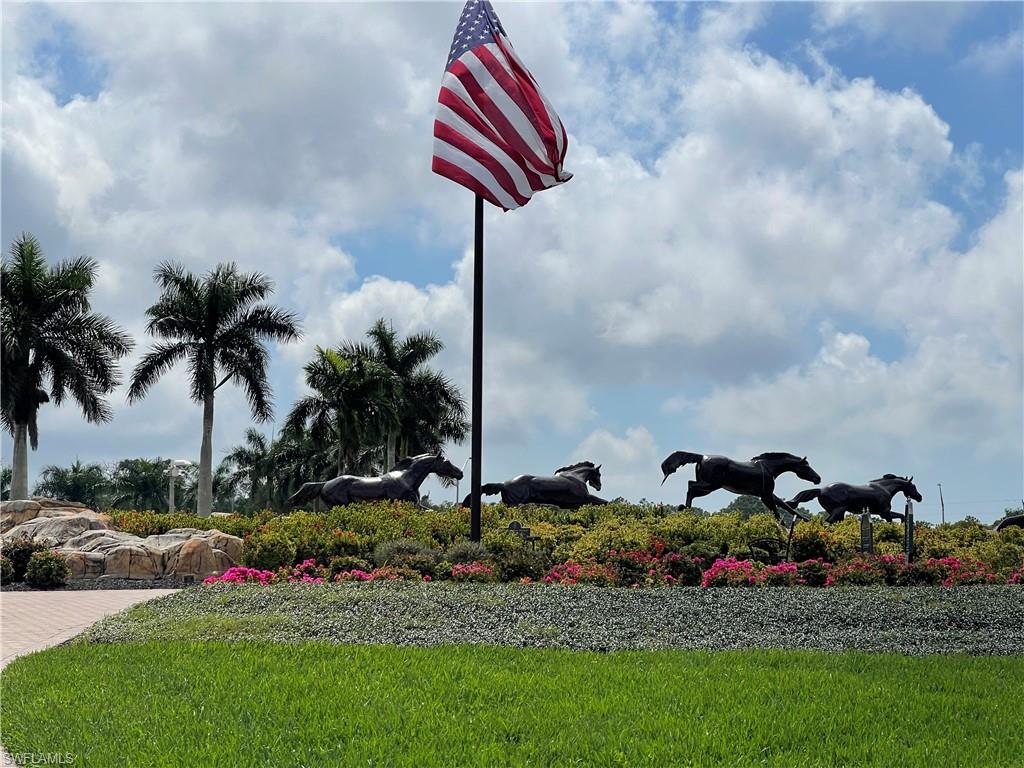 9009 Michael Circle, Unit 1110 Naples, FL 34113 - Photo 44 of 48 a front view of a house with lots of flower and trees