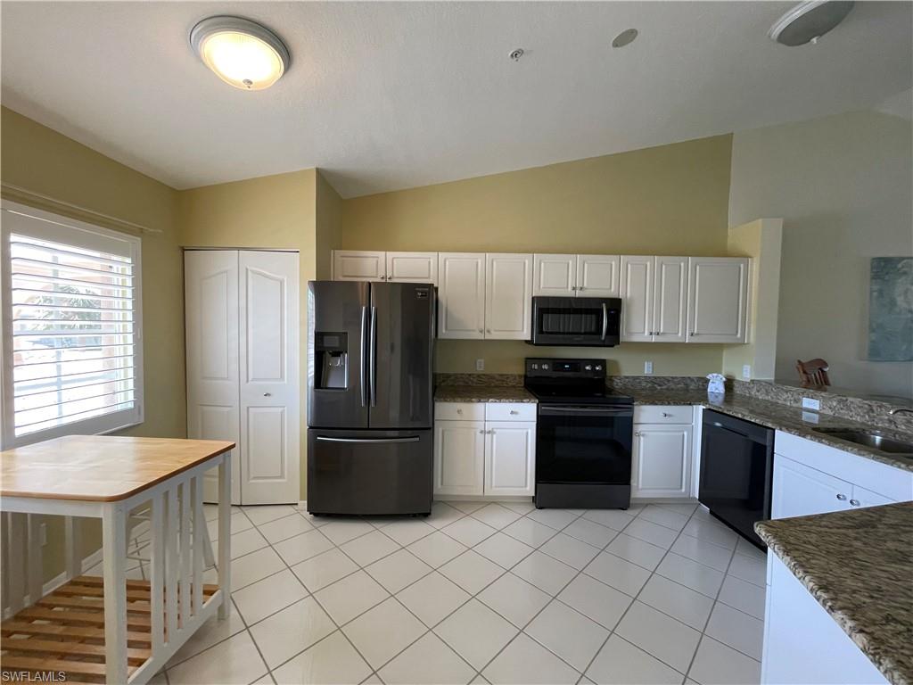 9009 Michael Circle, Unit 1110 Naples, FL 34113 - Photo 5 of 48 a kitchen with a sink a stove and refrigerator