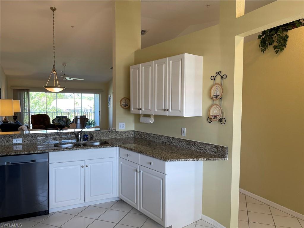 9009 Michael Circle, Unit 1110 Naples, FL 34113 - Photo 7 of 48 a kitchen with a sink and cabinets