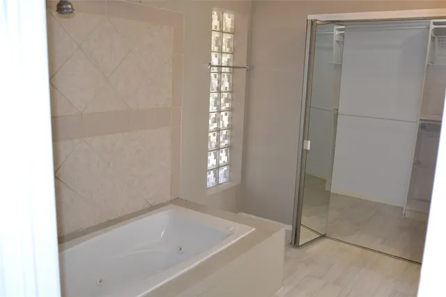 a bathroom with a bathtub and shower