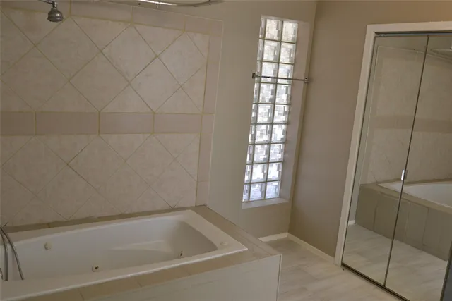 a bathroom with a bathtub and shower