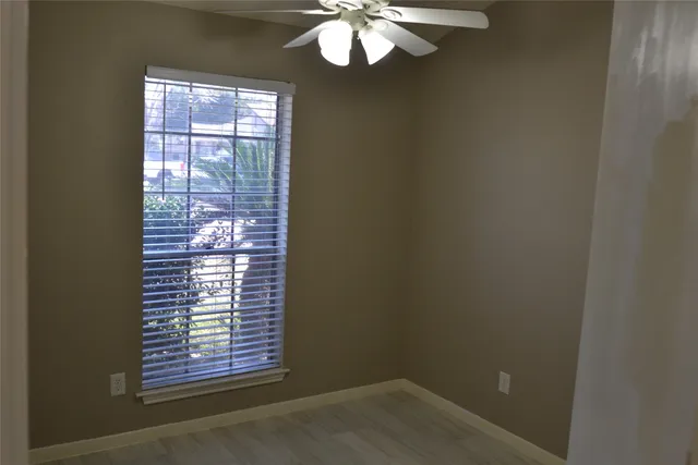 a view of wooden floor and a chandelier in a room