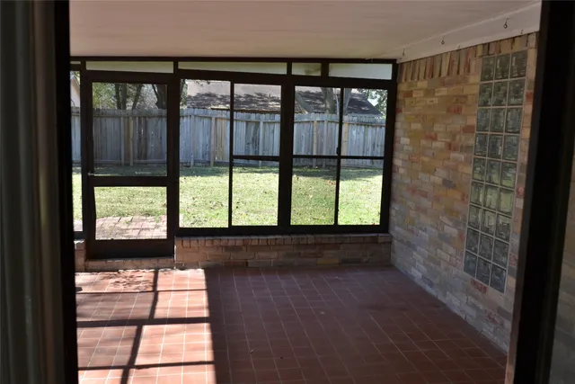 a view of empty room with large windows