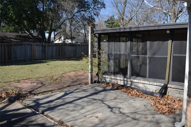 a backyard of a house with table and chairs