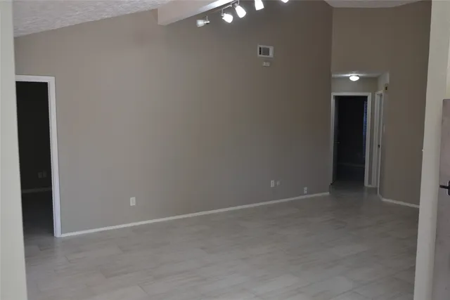 a view of an empty room with glass door