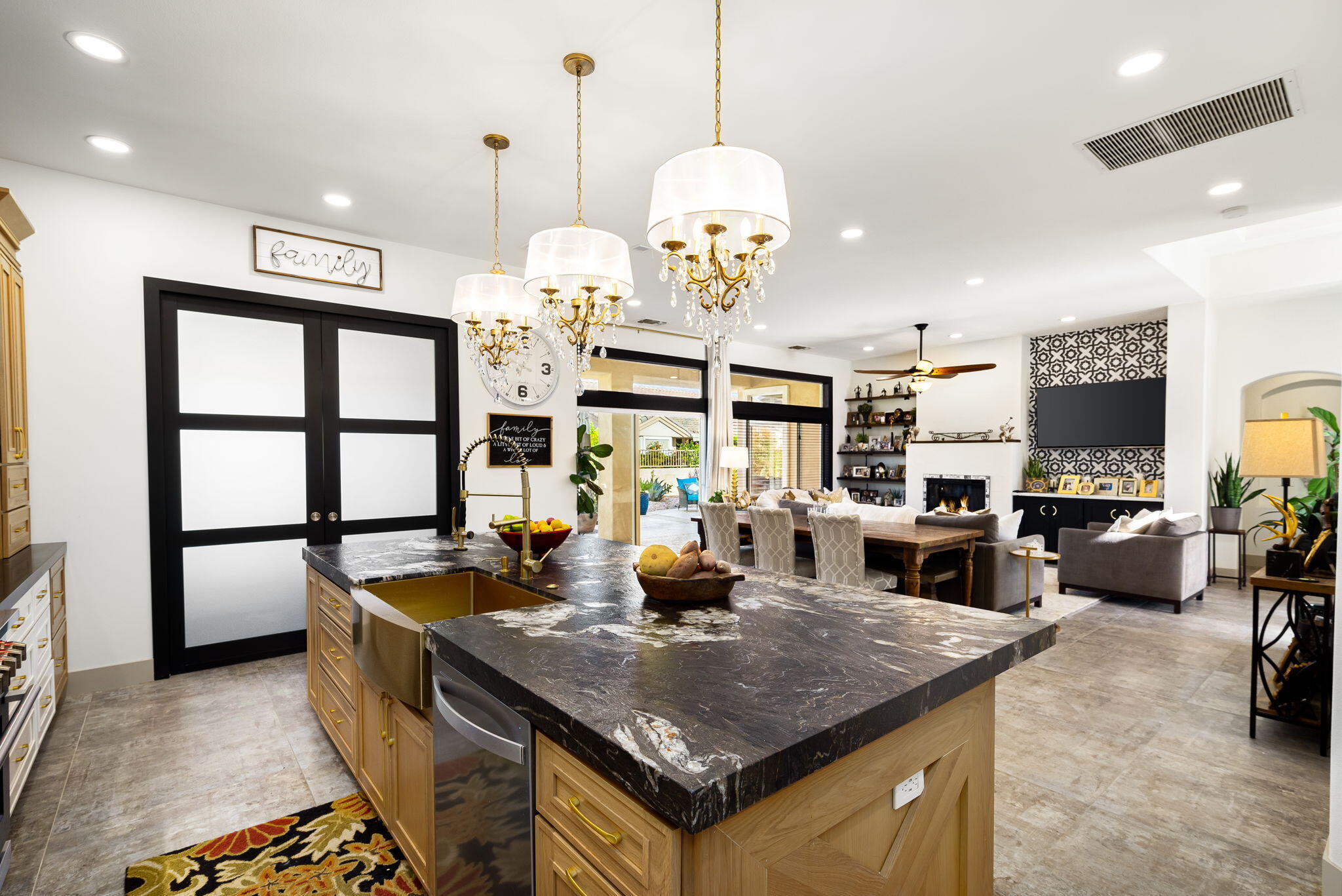 78618 Dancing Waters Road Palm Desert, CA 92211 - Photo 23 of 38 a kitchen with stainless steel appliances granite countertop a stove a refrigerator a sink a dining table and chairs with wooden floor