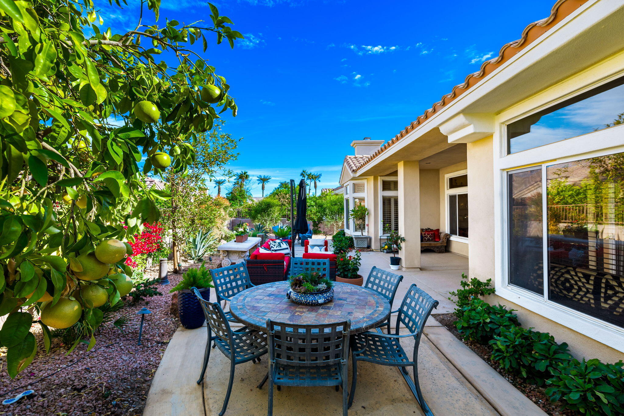 78618 Dancing Waters Road Palm Desert, CA 92211 - Photo 31 of 38 a view of a house with backyard sitting area and garden