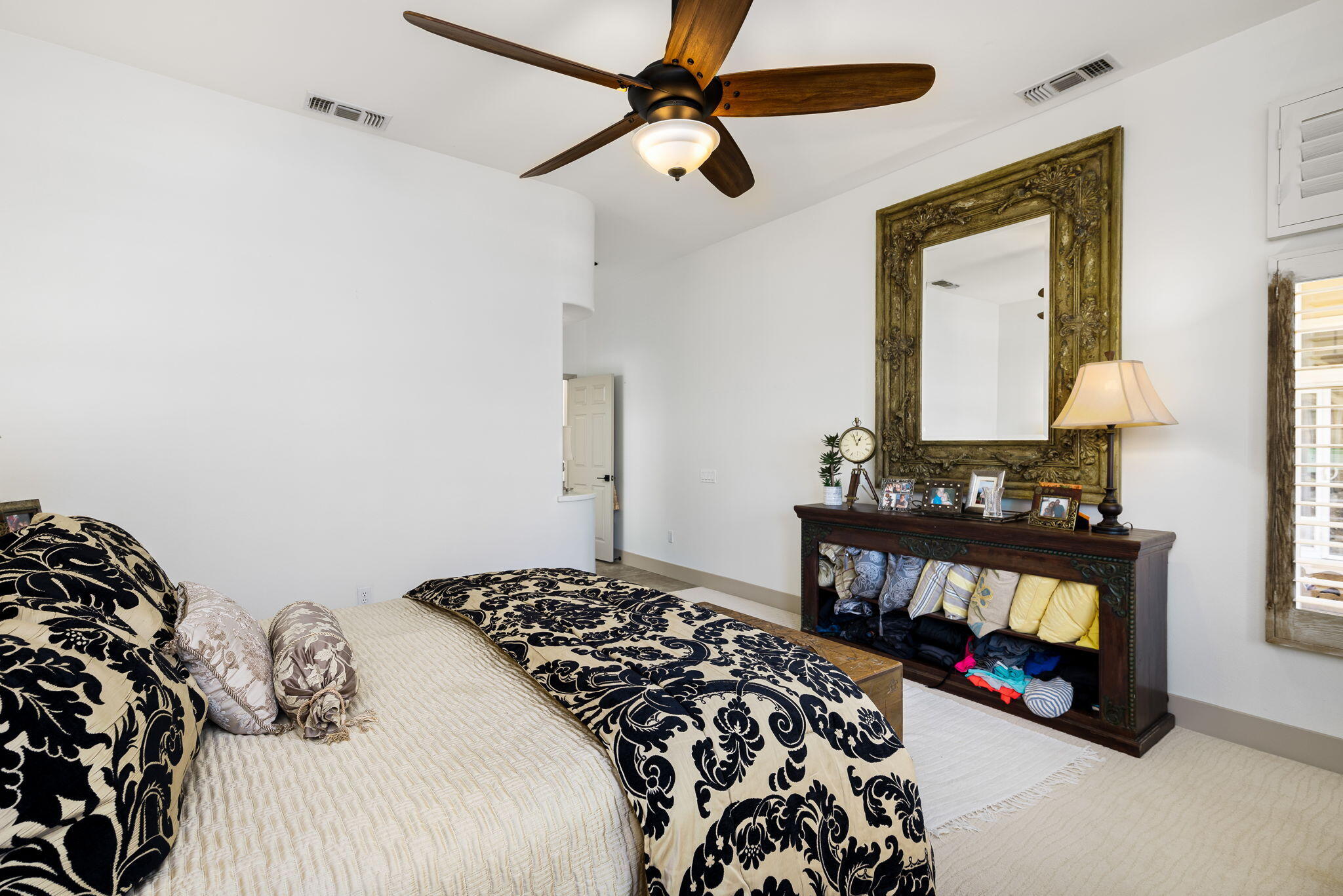 78618 Dancing Waters Road Palm Desert, CA 92211 - Photo 33 of 38 a bedroom with a bed and a table in it