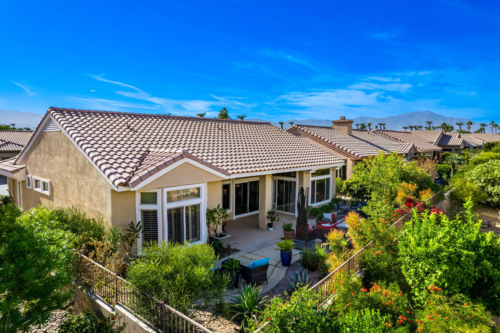 78618 Dancing Waters Road Palm Desert, CA 92211 - Photo 7 of 38 a front view of a house with a garden
