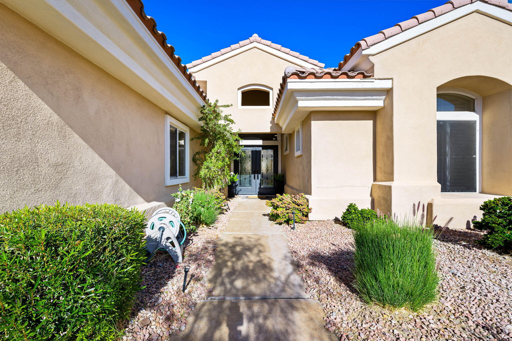 78618 Dancing Waters Road Palm Desert, CA 92211 - Photo 9 of 38 a front view of a house with a garden