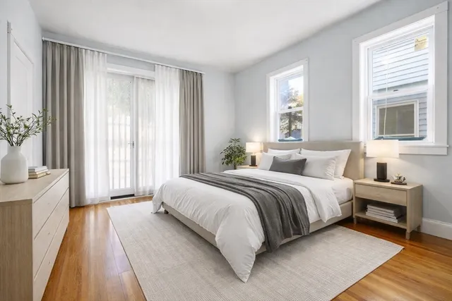 a spacious bedroom with a bed and a window