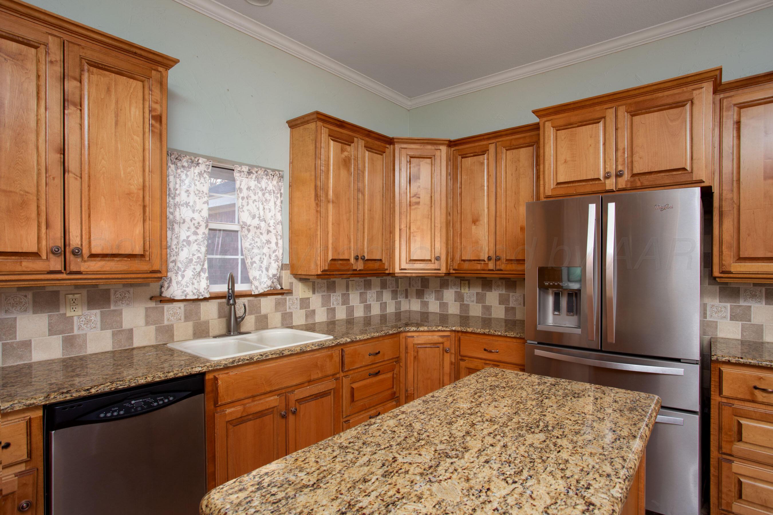 8900 Ottobahn Amarillo, TX 79119 - Photo 18 of 56 a kitchen with stainless steel appliances granite countertop a refrigerator sink and cabinets