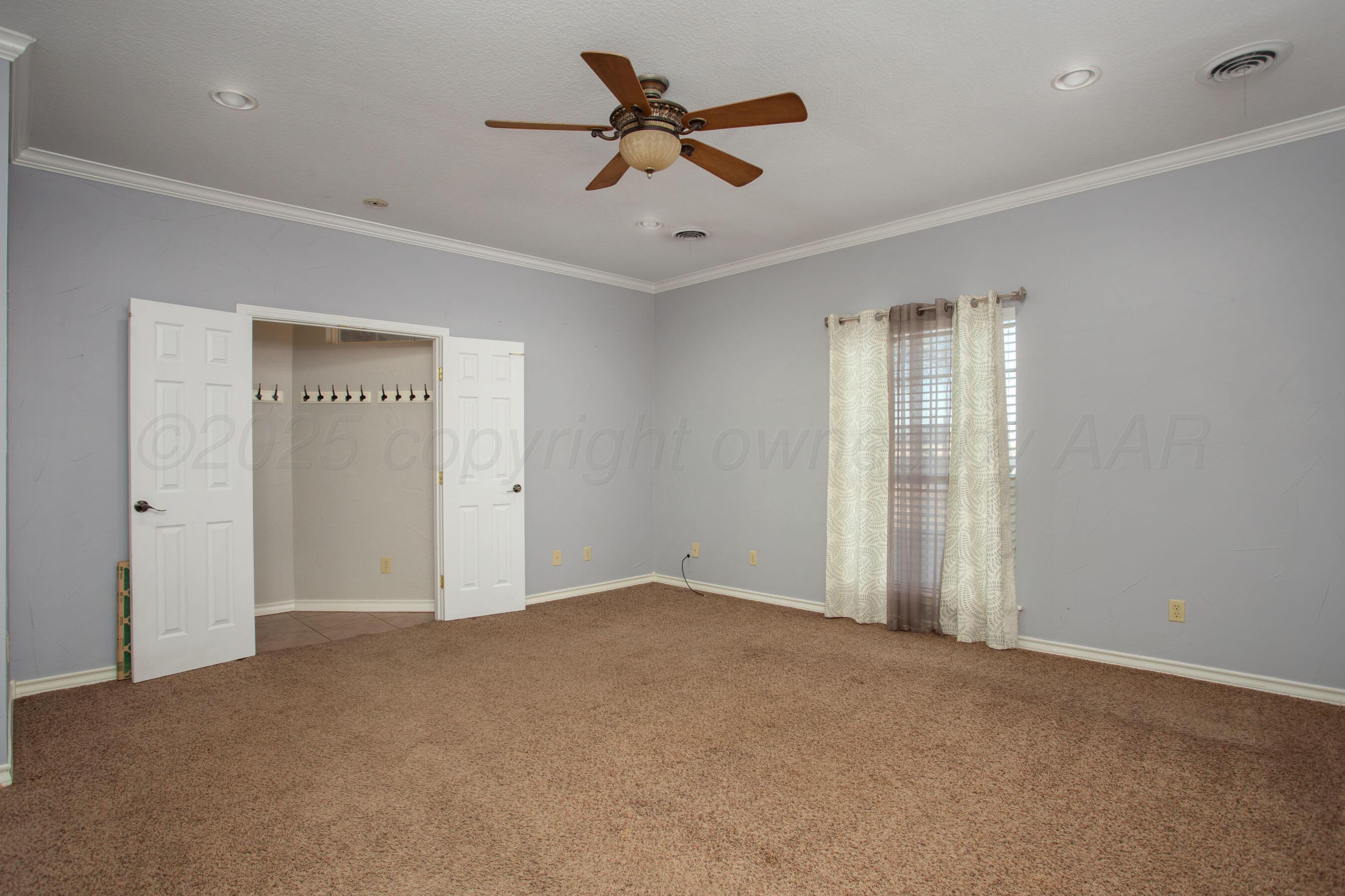 8900 Ottobahn Amarillo, TX 79119 - Photo 22 of 56 an empty room with closet and fan