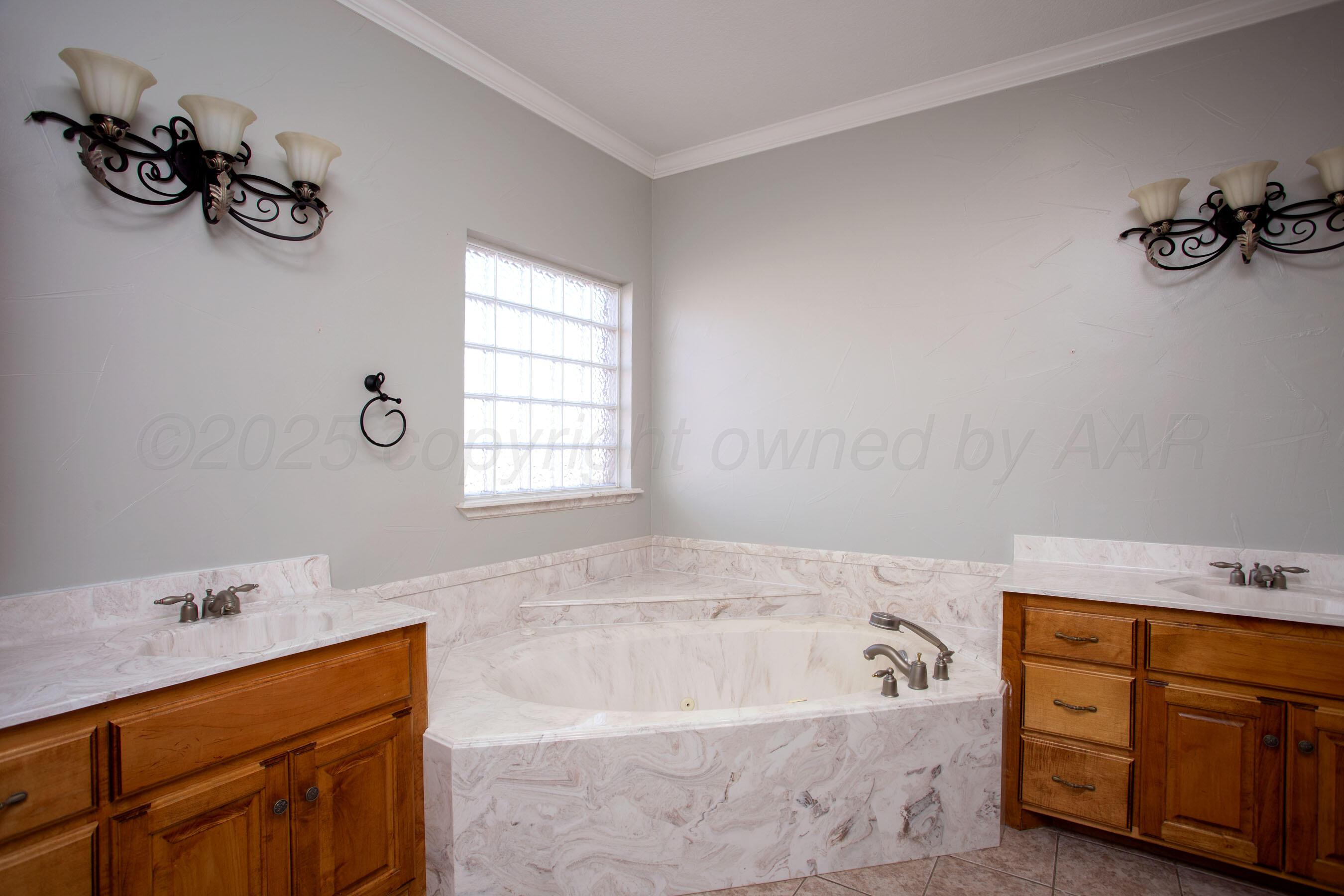 8900 Ottobahn Amarillo, TX 79119 - Photo 24 of 56 a bathroom with a tub sink and mirror