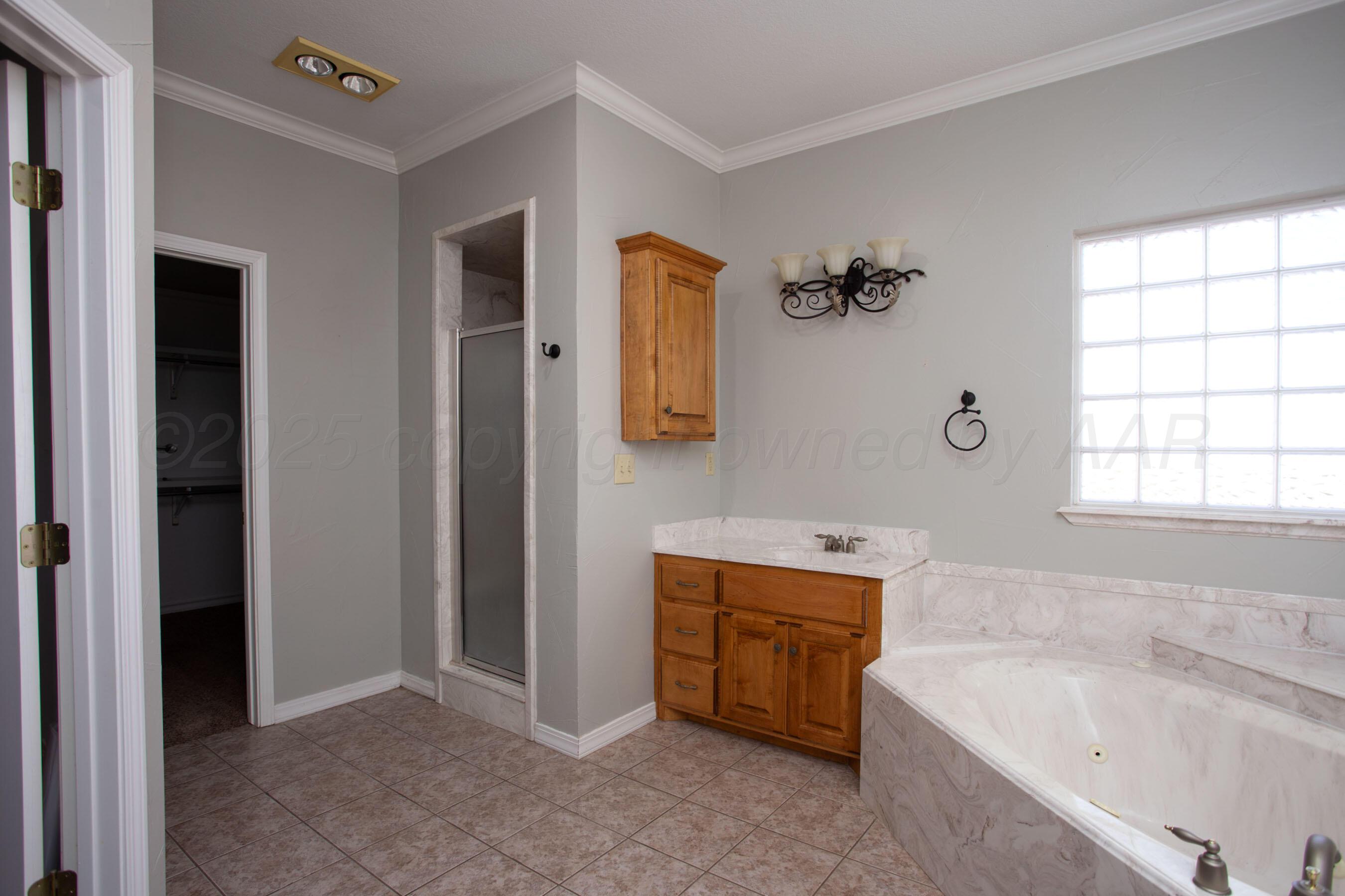 8900 Ottobahn Amarillo, TX 79119 - Photo 25 of 56 a bathroom with a tub sink and mirror