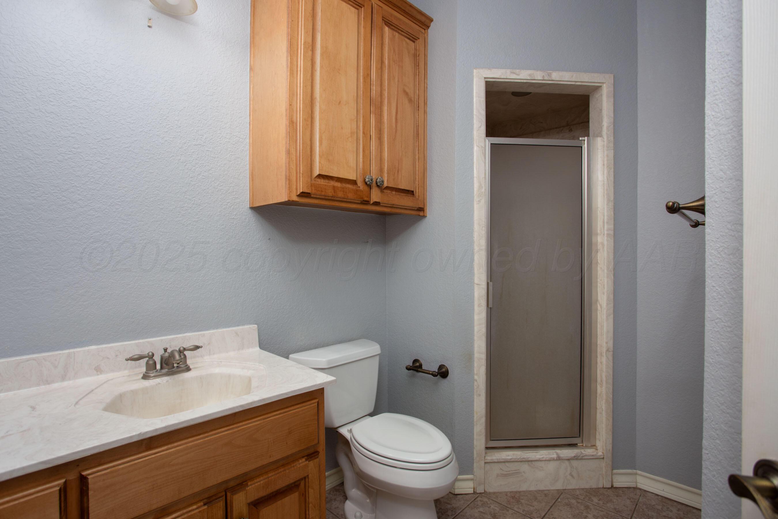 8900 Ottobahn Amarillo, TX 79119 - Photo 28 of 56 a bathroom with a toilet sink vanity and mirror
